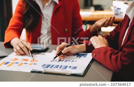 Businesswoman and team analyzing financial statement Finance task. with smart phone and laptop and tablet. Wealth management concept in office Businesswoman and team analyzing financial statement Finance task. with smart phone and laptop and tablet. Wealth management concept in office 107364617