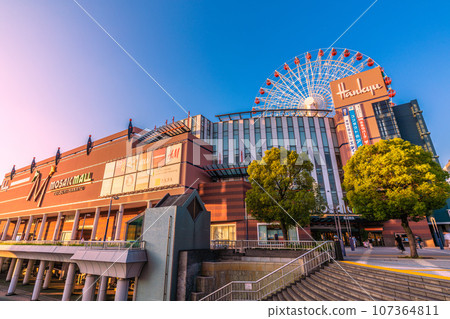 Yokohama cityscape, Japan, September. In front of Center Kita Station, view of the Ferris wheel and Tsuzuki Hankyu, etc., reflected in the blue sky and sunset Yokohama cityscape, Japan, September. In front of Center Kita Station, view of the Ferris wheel and Tsuzuki Hankyu, etc., reflected in the blue sky and sunset 107364811