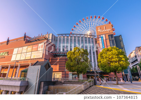 Yokohama cityscape, Japan, September. In front of Center Kita Station, view of the Ferris wheel and Tsuzuki Hankyu, etc., reflected in the blue sky and sunset 107364815