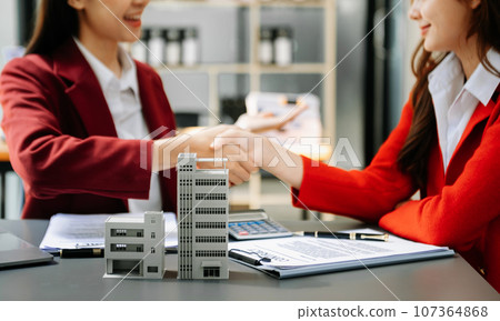 Signing a contract. Client and broker agent, lease agreement, successful deal and Young business sitting at the desk in office Signing a contract. Client and broker agent, lease agreement, successful deal and Young business sitting at the desk in office 107364868