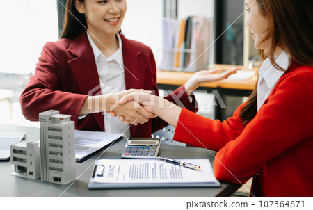Signing a contract. Client and broker agent, lease agreement, successful deal and Young business sitting at the desk in office Signing a contract. Client and broker agent, lease agreement, successful deal and Young business sitting at the desk in office 107364871