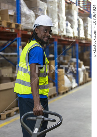 Man African American worker wear safety uniform push load cart 107364924