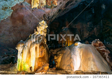 Crimea, Russia. Stalactites, stalagmites on the walls of the Emine-Bair-Khosar cave. Template for design. Selective sharpness. Crimea, Russia. Stalactites, stalagmites on the walls of the Emine-Bair-Khosar cave. Template for design. Selective sharpness. 107365411