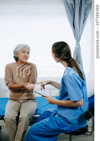 Caucasian doctor smiling take care of a young patient in hospital. Friendly nurse or therapeutic treat client Professional medical service concept. Caucasian doctor smiling take care of a young patient in hospital. Friendly nurse or therapeutic treat client Professional medical service concept. 107366360