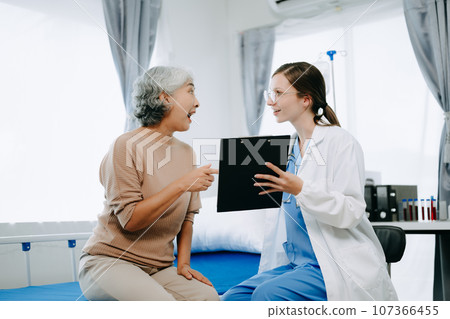 Caucasian doctor smiling take care of a young patient in hospital. Friendly nurse or therapeutic treat client Professional medical service concept. 107366455