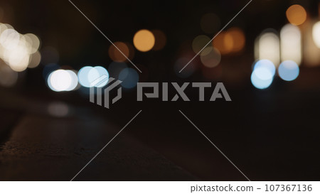 Bokeh background of night city with car light passing by Bokeh background of night city with car light passing by 107367136
