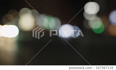 Bokeh background of night city with car light passing by Bokeh background of night city with car light passing by 107367138