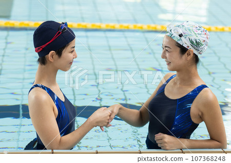 woman enjoying swimming woman enjoying swimming 107368248