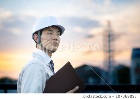 A man wearing work clothes A man wearing work clothes 107369853