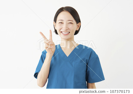 Female doctor giving a peace sign, white background 107370173