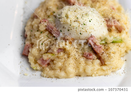 Carbonara risotto with hot spring egg Carbonara risotto with hot spring egg 107370431