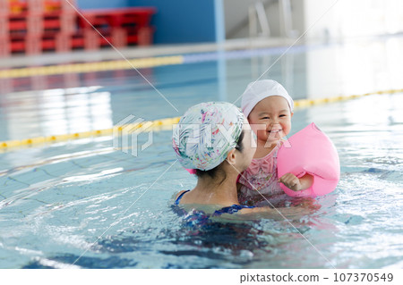 Parent and child enjoying a baby swim Parent and child enjoying a baby swim 107370549