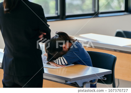 Elementary school girl who starts crying after being scolded by her teacher 107370727