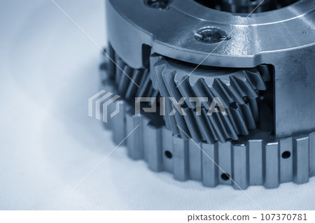 Close-up scene of automatic transmission gear spare parts in the light blue scene. Close-up scene of automatic transmission gear spare parts in the light blue scene. 107370781