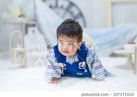 Birthday photo set shows a baby with a painful expression on his 1st birthday as he crawls carrying rice cakes on his back for the rest of his life. Birthday photo set shows a baby with a painful expression on his 1st birthday as he crawls carrying rice cakes on his back for the rest of his life. 107371028