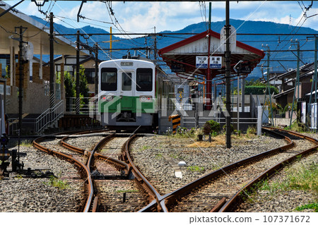 Japanese station scenery: Train stopped at the station 107371672