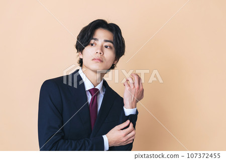 Portrait of a young businessman in a suit 107372455