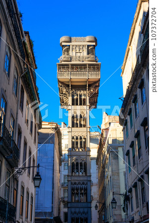 Santa Justa lift in Lisbon, Portugal. Famous landmark and entertaining tourist attraction with viewing platform upstairs Santa Justa lift in Lisbon, Portugal. Famous landmark and entertaining tourist attraction with viewing platform upstairs 107372704