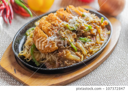 Luxury bolognese pasta topped with Milanese cutlet Luxury bolognese pasta topped with Milanese cutlet 107372847