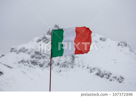 Italy national flag against winter mountains 107372896