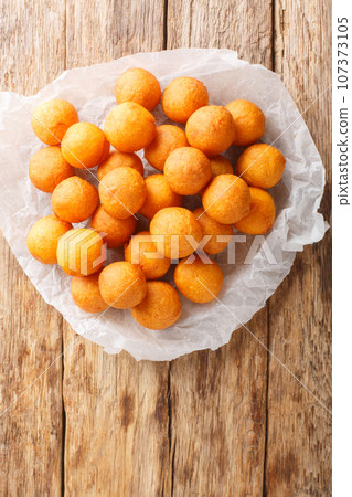 Khanom khai nok kratha Thai Deep Fried Sweet Potato Balls closeup. Vertical top view 107373105