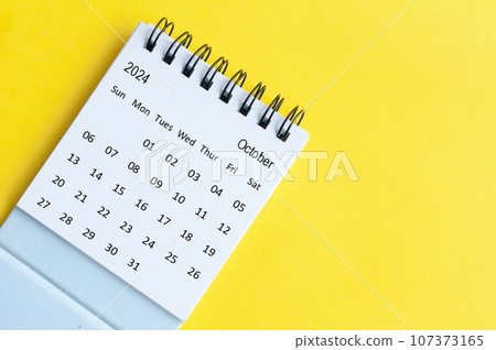 October 2024 table calendar on yellow cover background with customizable space for text October 2024 table calendar on yellow cover background with customizable space for text 107373165