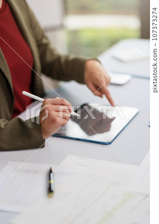 Concept of business office woman working,Businesswoman smile while working about her invesment plan with analyzing document and business investment graph data by using laptop on desk in workstation. Concept of business office woman working,Businesswoman smile while working about her invesment plan with analyzing document and business investment graph data by using laptop on desk in workstation. 107373274