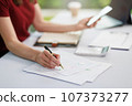 Concept of business office woman working,Businesswoman smile while working about her invesment plan with analyzing document and business investment graph data by using laptop on desk in workstation. 107373277