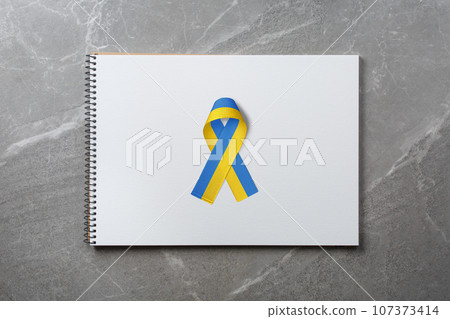 yellow and blue ribbon on notepad yellow and blue ribbon on notepad 107373414