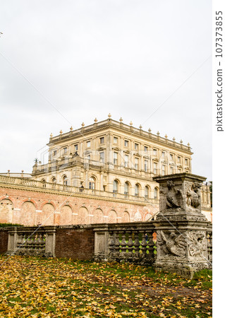 Cliveden Manor House, a historic building made of stone and red brick under a cloudy sky Cliveden Manor House, a historic building made of stone and red brick under a cloudy sky 107373855