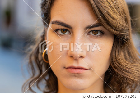 Sad unhappy frustrated woman walking alone in city street, feeling bad, annoyed, grief, problem 107375205