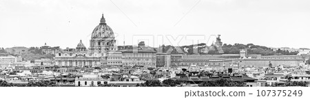 Vatican City with St. Peter's Basilica. Panoramic skyline view from Castel Sant'Angelo, Rome, Italy. Black and white image. 107375249
