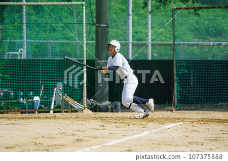 Batter watching the direction of the ball 107375888