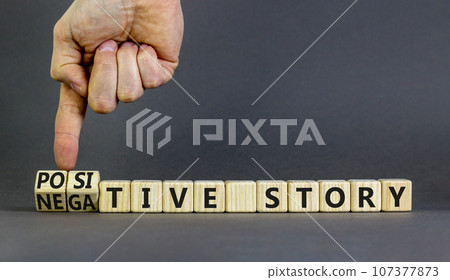 Positive or negative story symbol. Businessman turns cubes, changes concept words Negative story to Positive story. Beautiful grey background. Business positive negative story concept. Copy space. 107377873
