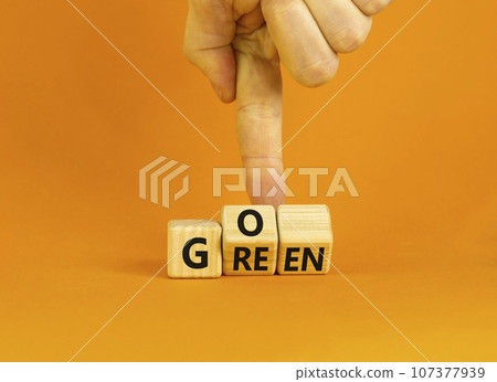 Ecology and go green symbol. Concept words Go green on wooden cubes. Businessman hand. Beautiful orange table orange background. Business ecological and go green concept. Copy space. 107377939