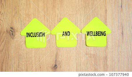 Inclusion and wellbeing symbol. Concept words Inclusion and wellbeing on beautiful yellow paper house. Beautiful wooden background. Motivational inclusion and wellbeing concept. Copy space. Inclusion and wellbeing symbol. Concept words Inclusion and wellbeing on beautiful yellow paper house. Beautiful wooden background. Motivational inclusion and wellbeing concept. Copy space. 107377940