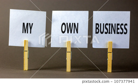 My own business symbol. Concept words My own business on beautiful white paper on clothespin. Beautiful grey background. Business motivational my own business concept. Copy space. 107377941