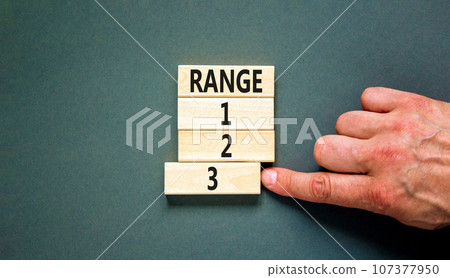 Time to range 3 symbol. Concept word Range 1 2 3 on wooden block. Businessman hand. Beautiful grey table grey background. Business planning and time to range 3 concept. Copy space. Time to range 3 symbol. Concept word Range 1 2 3 on wooden block. Businessman hand. Beautiful grey table grey background. Business planning and time to range 3 concept. Copy space. 107377950