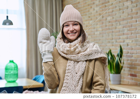 Winter portrait of young happy woman in comfortable winter clothes Winter portrait of young happy woman in comfortable winter clothes 107378172