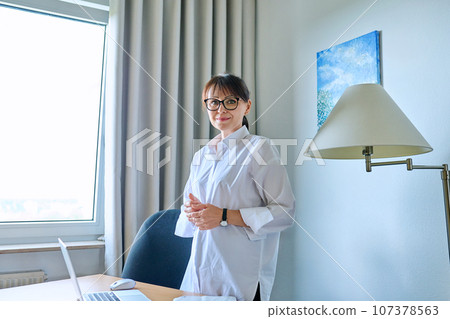 Portrait of business confident mature woman in home office 107378563