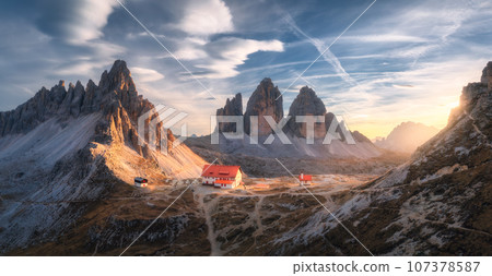 Aerial view of mountains, beautiful house and church at sunset 107378587