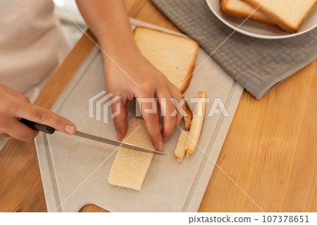 a woman prepares breakfast bread 107378651