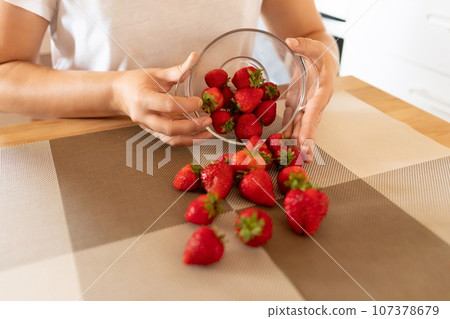 A close-up of fresh farm strawberries in a bowl A close-up of fresh farm strawberries in a bowl 107378679