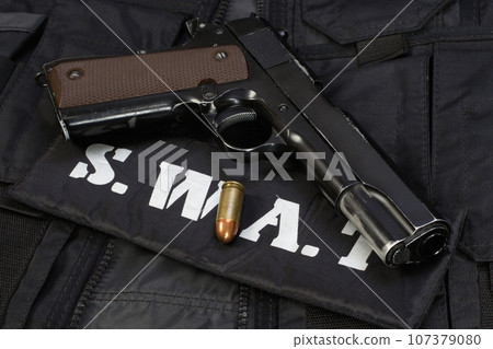 Police handgun on black uniform Police handgun on black uniform 107379080