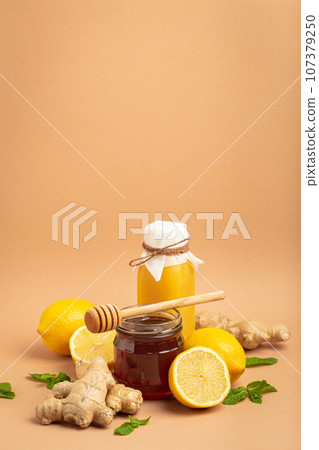 Composition with detox drink, sea buckthorn berries, lemons, mint, ginger, honey in glass jar. Food for immunity stimulation and against flu. Healthy natural remedies to boost immune system Composition with detox drink, sea buckthorn berries, lemons, mint, ginger, honey in glass jar. Food for immunity stimulation and against flu. Healthy natural remedies to boost immune system 107379250