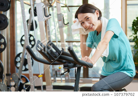 A woman riding an aero bike A woman riding an aero bike 107379702