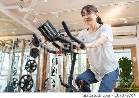 A woman riding an aero bike 107379704