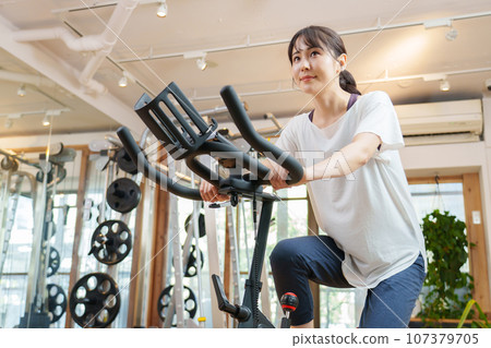 A woman riding an aero bike 107379705