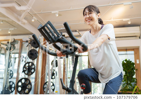 A woman riding an aero bike 107379706