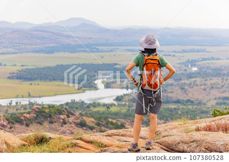 Woman hiking in the Elk Mountain Trail of the Wichita Mountains National Wildlife Refuge Woman hiking in the Elk Mountain Trail of the Wichita Mountains National Wildlife Refuge 107380528